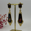 Boucles d’oreilles pendantes fleuries acier inoxydable – Noir & Or, style baroque chic.