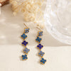 Boucles d’oreilles pendantes Chance bleues en acier inoxydable doré