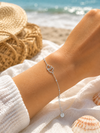 Bracelet fin cœurs argentés entrelacés en acier inoxydable – bijou femme élégant et intemporel