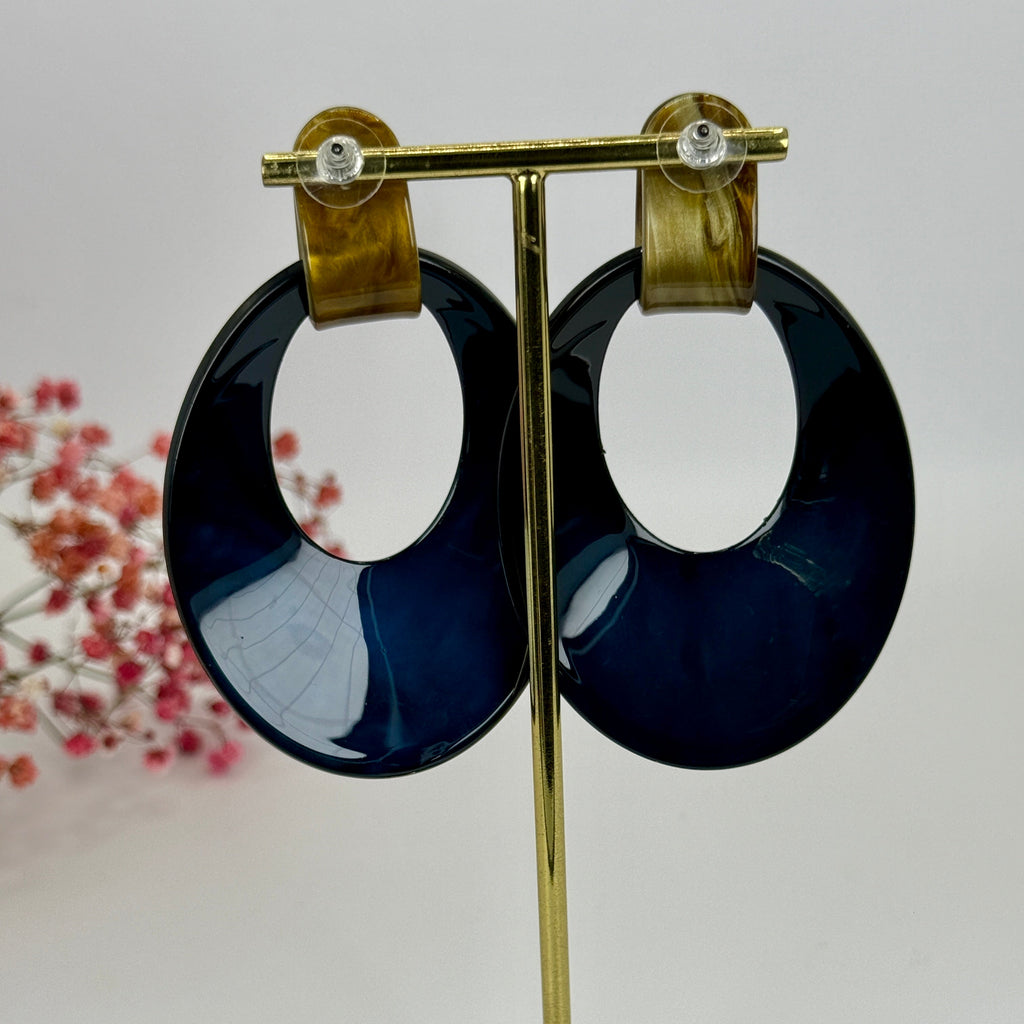 Ovale dunkelblaue Ohrhänger aus Kunstharz.