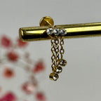 Ketten- und Zirkonia-Piercing – gold-/silberfarbener Edelstahlstecker mit Zirkonia.