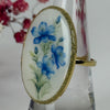 Bague ajustable dorée en acier inoxydable – Résine époxy motif fleurs bleues | Bijou élégant