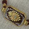 Braunes Kordelarmband mit goldenem Augen- und Herzmedaillon – Bohème-Stil