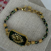 Armband aus grünem und schwarzem Kordel – Medaillon mit strahlendem Herz in Gold