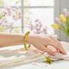 Armreif, zu öffnen, aus vergoldetem Messing mit gelbem, emailliertem Blumenmotiv – Innendurchmesser 6 cm