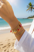 Bracelet charms marin rouge et coquillages en acier inoxydable doré ajustable