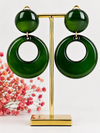 Ronde clipoorbellen van blauwe of groene hars.
